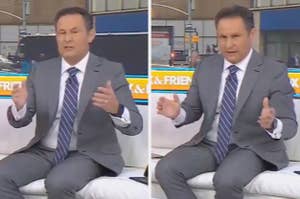 News anchor in a gray suit gestures energetically while seated on a studio set