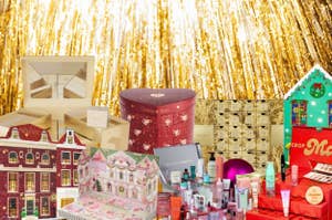 Assorted holiday-themed advent calendars and gift sets displayed against sparkling background